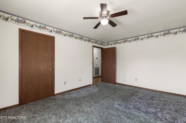 unfurnished bedroom featuring ceiling fan and dark colored carpet