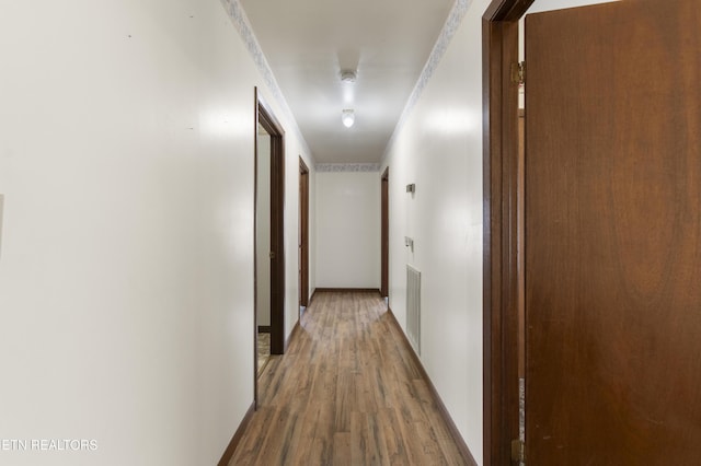 hallway with hardwood / wood-style floors