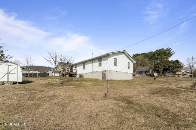 exterior space with a storage shed and a lawn