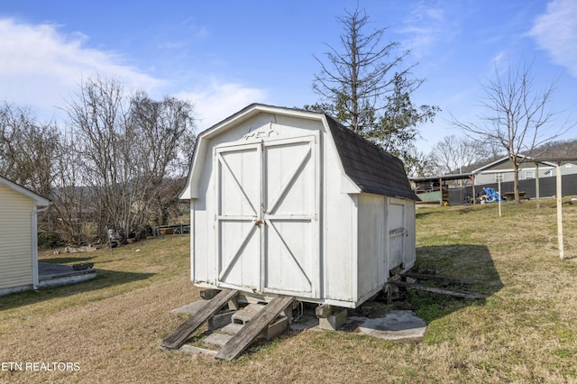 view of outbuilding featuring a yard