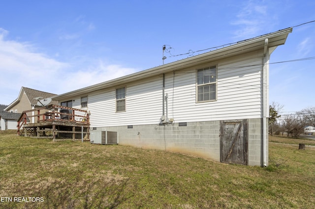 rear view of property featuring a wooden deck, a yard, and central AC unit