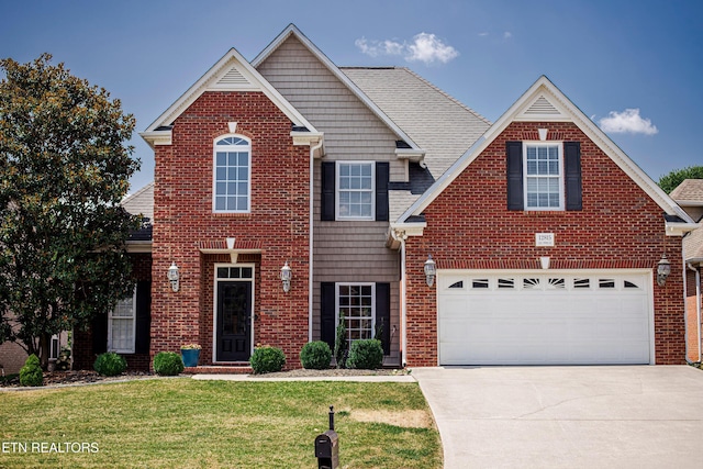 view of front of home with a garage and a front yard