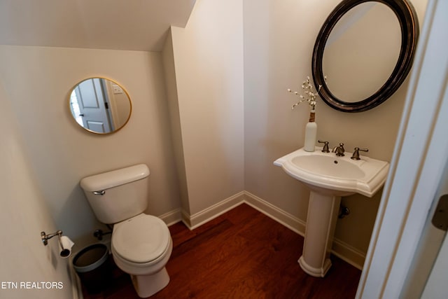 bathroom featuring wood-type flooring and toilet