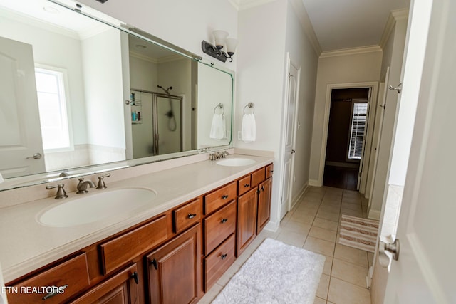 bathroom featuring vanity, tile patterned flooring, a shower with door, and ornamental molding