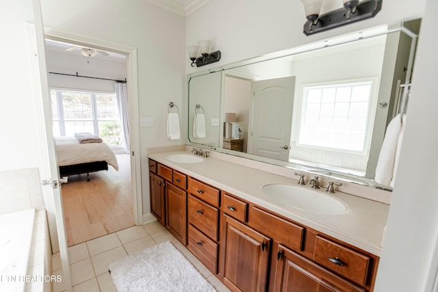 bathroom featuring tile patterned flooring, vanity, and crown molding