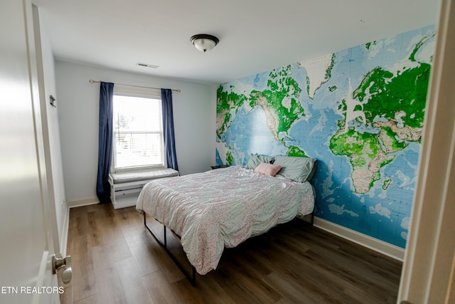 bedroom featuring dark hardwood / wood-style flooring