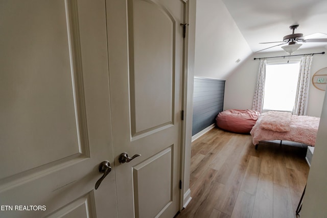 bedroom with lofted ceiling, light hardwood / wood-style flooring, and ceiling fan