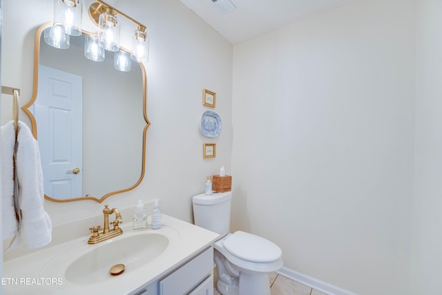 bathroom featuring vanity, tile patterned flooring, and toilet