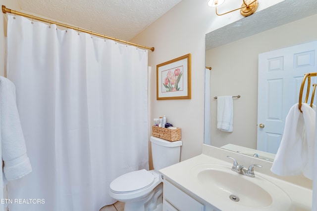 bathroom featuring vanity, toilet, and a textured ceiling