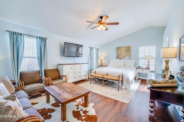 bedroom featuring ceiling fan, dark hardwood / wood-style flooring, and vaulted ceiling