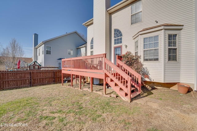 back of property featuring a yard and a deck