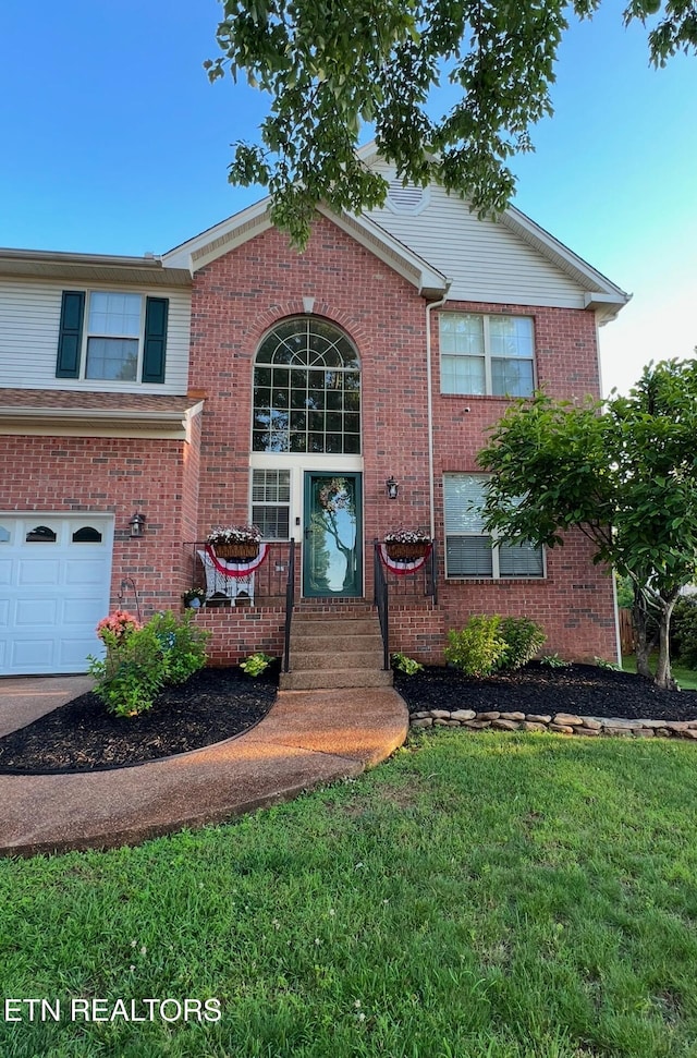 view of front facade with a garage and a front lawn