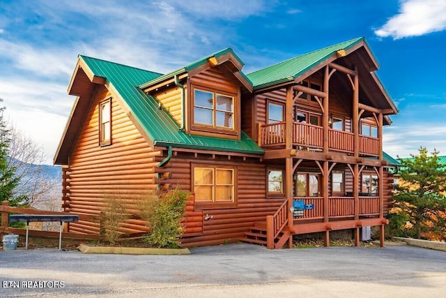 log home featuring a balcony