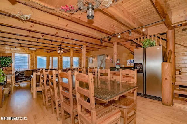 dining space with rail lighting, wood ceiling, light hardwood / wood-style flooring, wooden walls, and beam ceiling