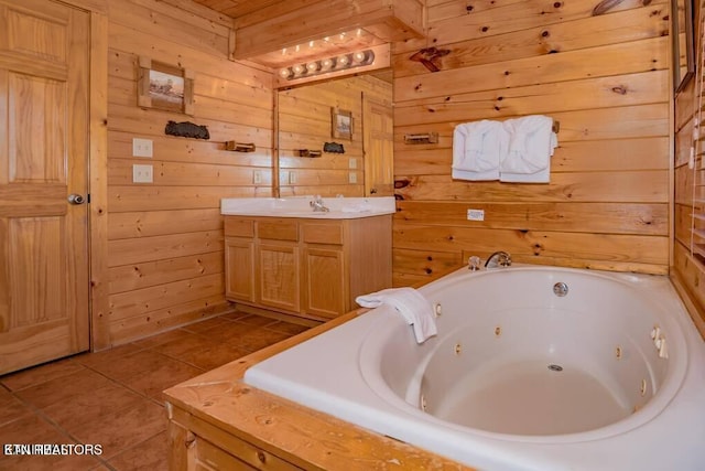 bathroom featuring tile patterned flooring, vanity, tiled tub, and wooden walls