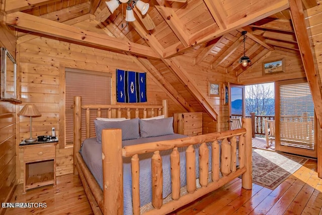 bedroom with vaulted ceiling with beams, light hardwood / wood-style flooring, and wood walls