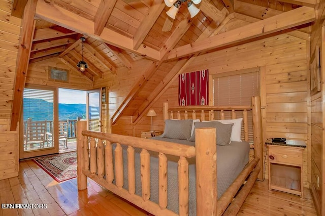 bedroom with vaulted ceiling with beams, light hardwood / wood-style flooring, wooden ceiling, and wood walls