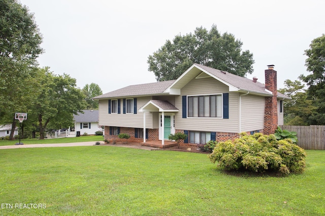 bi-level home with a front lawn