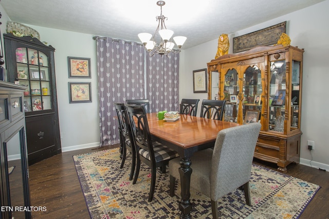 dining room featuring an inviting chandelier, dark hardwood / wood-style floors, and a textured ceiling