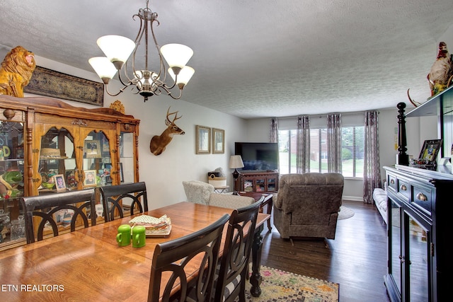 dining room featuring dark hardwood / wood-style flooring, a chandelier, and a textured ceiling