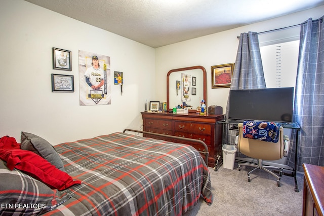 bedroom with light colored carpet and a textured ceiling