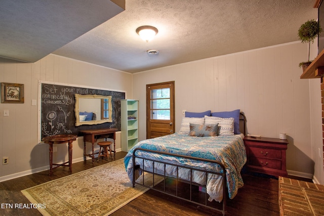 bedroom featuring dark wood-type flooring and a textured ceiling