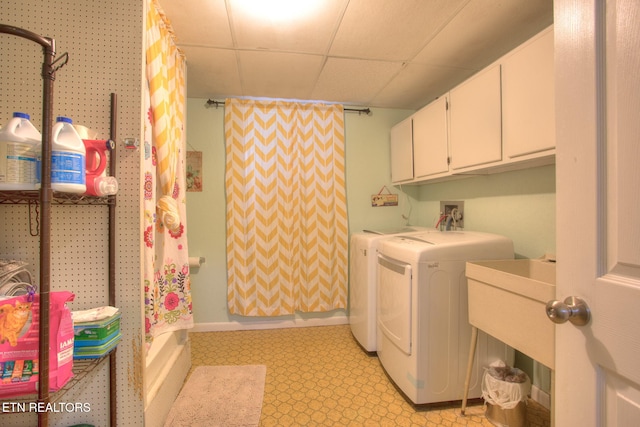 washroom featuring washing machine and dryer and cabinets