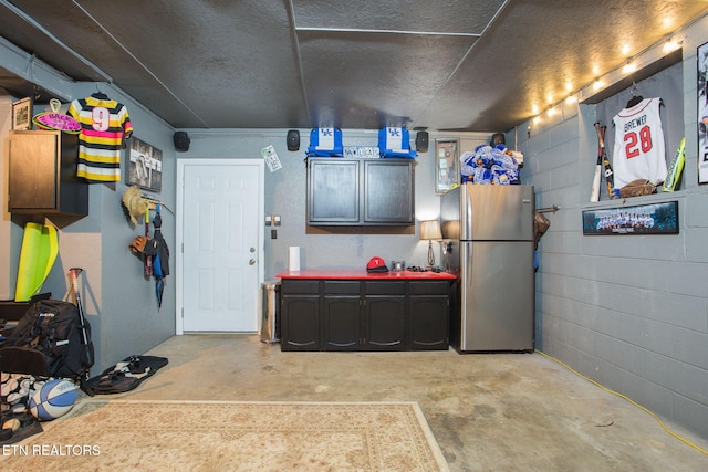 garage with stainless steel fridge