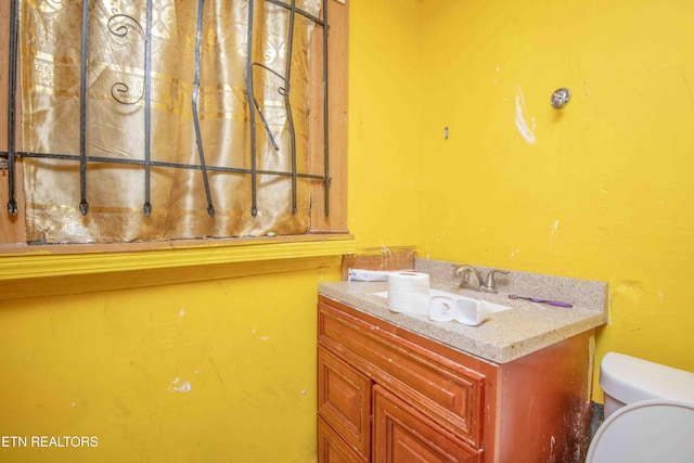 bathroom featuring vanity and toilet