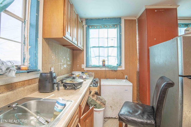 kitchen with sink and stainless steel fridge