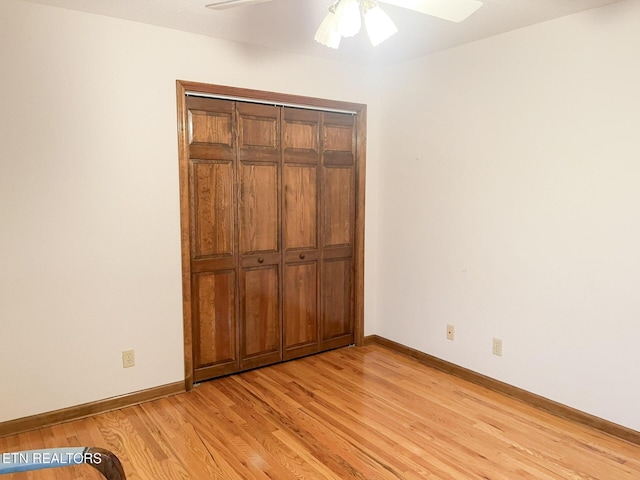 unfurnished bedroom featuring ceiling fan, a closet, and light hardwood / wood-style flooring