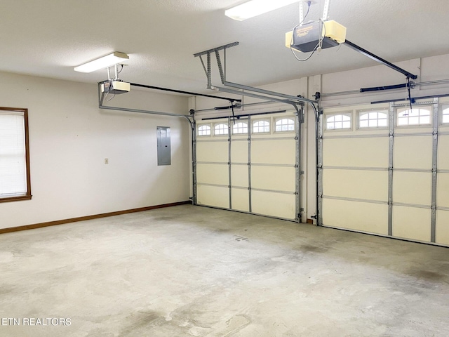 garage with a garage door opener and electric panel