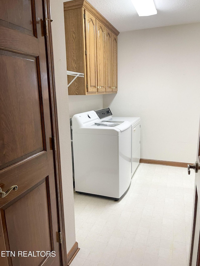 laundry area featuring cabinets and washer and dryer