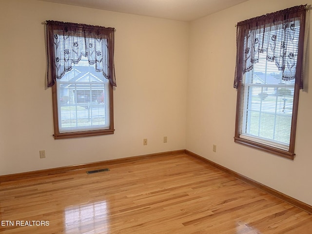 unfurnished room with light hardwood / wood-style floors