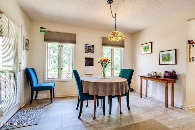 dining area featuring a textured ceiling