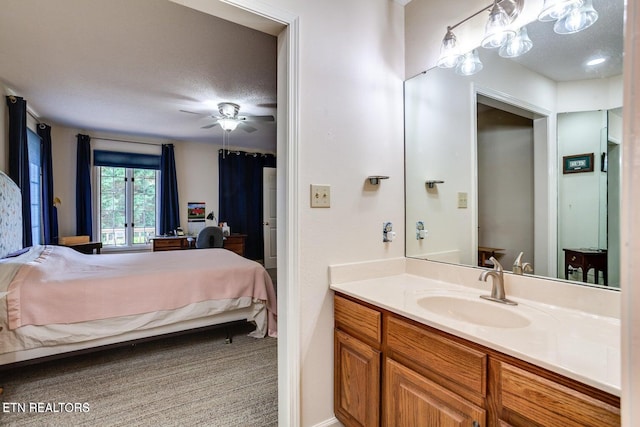 bathroom featuring vanity, a textured ceiling, and ceiling fan