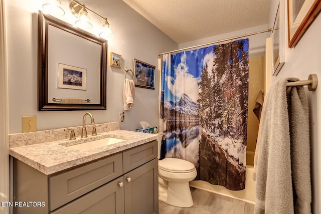 full bathroom with vanity, toilet, shower / tub combo, and a textured ceiling