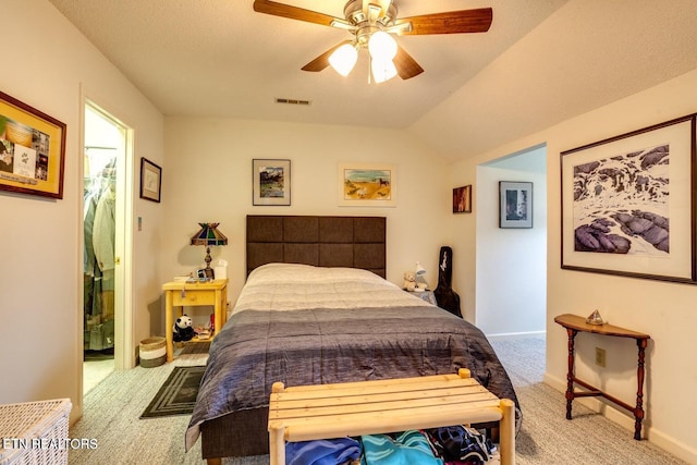 bedroom with vaulted ceiling, light carpet, and ceiling fan