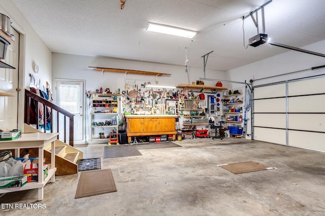 garage featuring a garage door opener and a workshop area