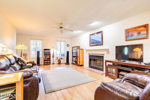 living room featuring wood-type flooring and ceiling fan