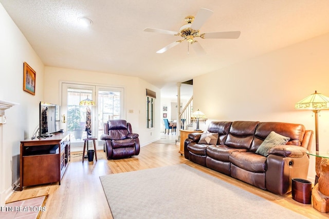 living room with ceiling fan and light wood-type flooring