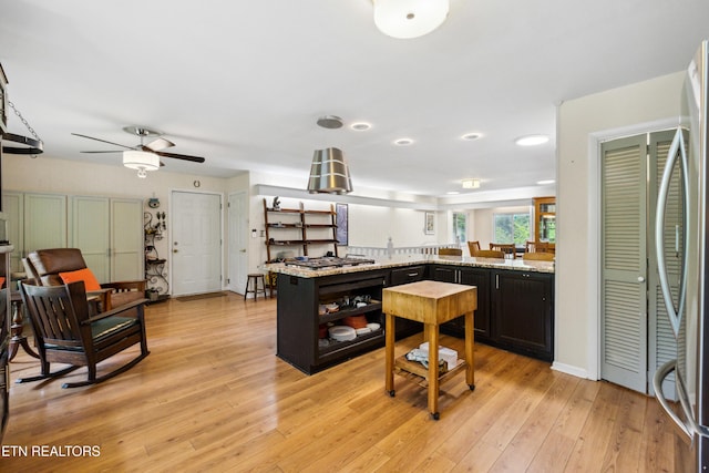 3516 Bluff Point Dr, Knoxville, TN 37920 - kitchen featuring open shelves, a ceiling fan, stainless steel appliances, light wood finished floors, and light stone counters