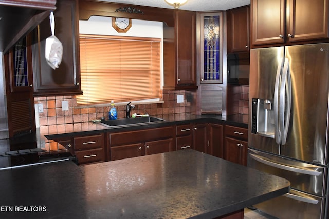 kitchen with tasteful backsplash, sink, and black appliances