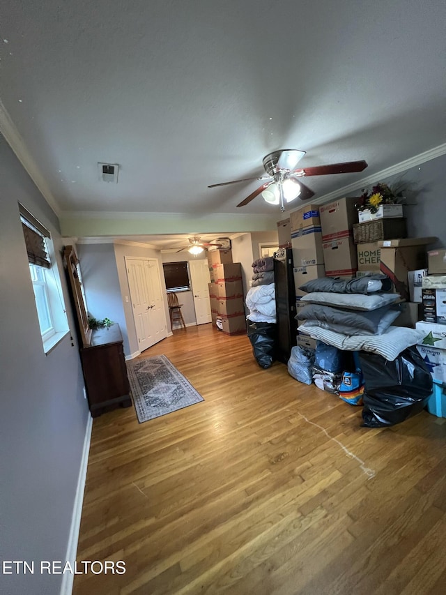 bedroom featuring crown molding, ceiling fan, and hardwood / wood-style flooring