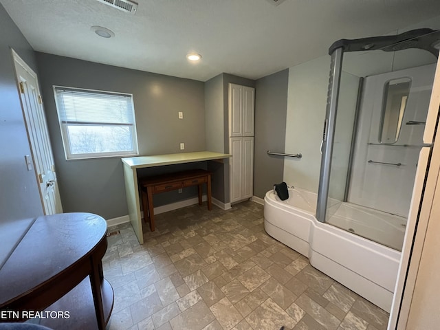 bathroom featuring shower / bath combination with glass door and washing machine and dryer