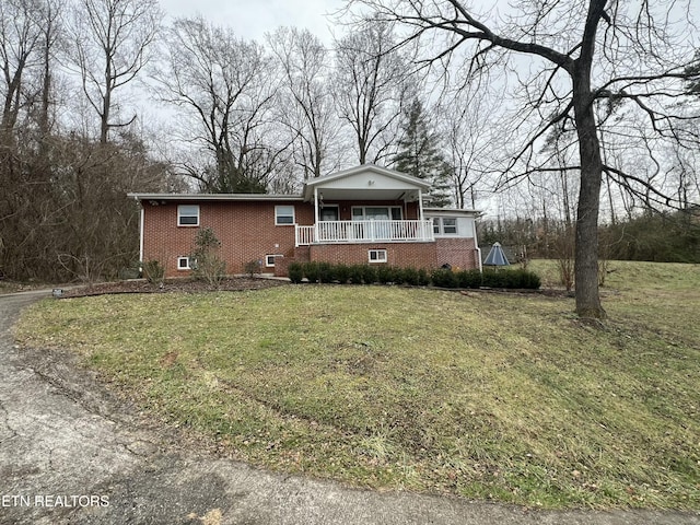 view of front of house with covered porch and a front yard