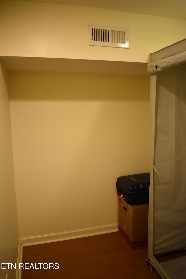 spacious closet with dark wood-type flooring