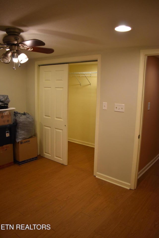 unfurnished bedroom with dark hardwood / wood-style floors, ceiling fan, and a closet