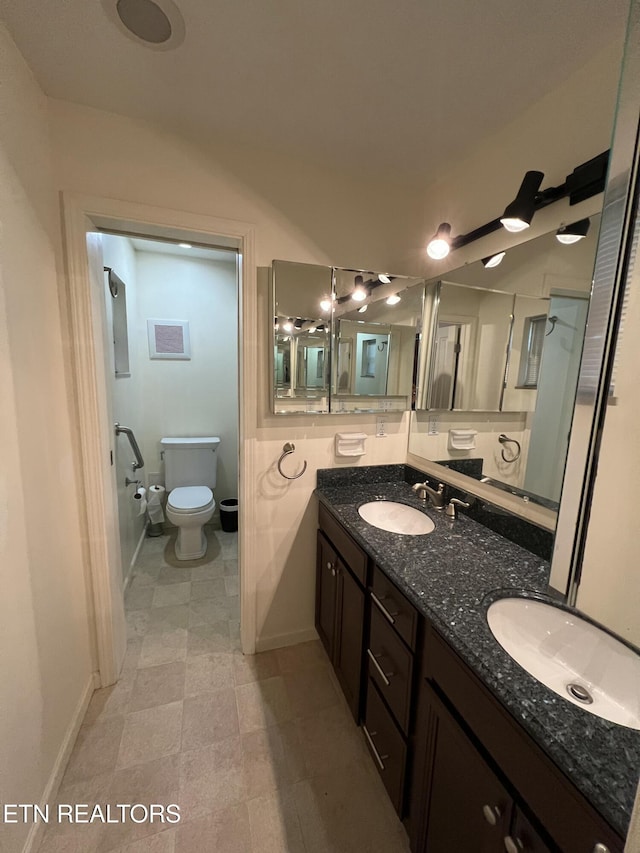 bathroom featuring vanity and toilet