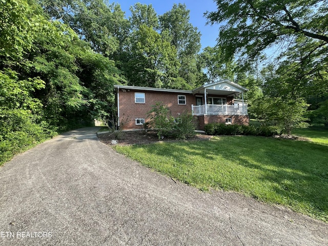 111 Old Evacuation Ln, Oliver Springs, TN 37840 - ranch-style home featuring brick siding, a front lawn, covered porch, and asphalt driveway